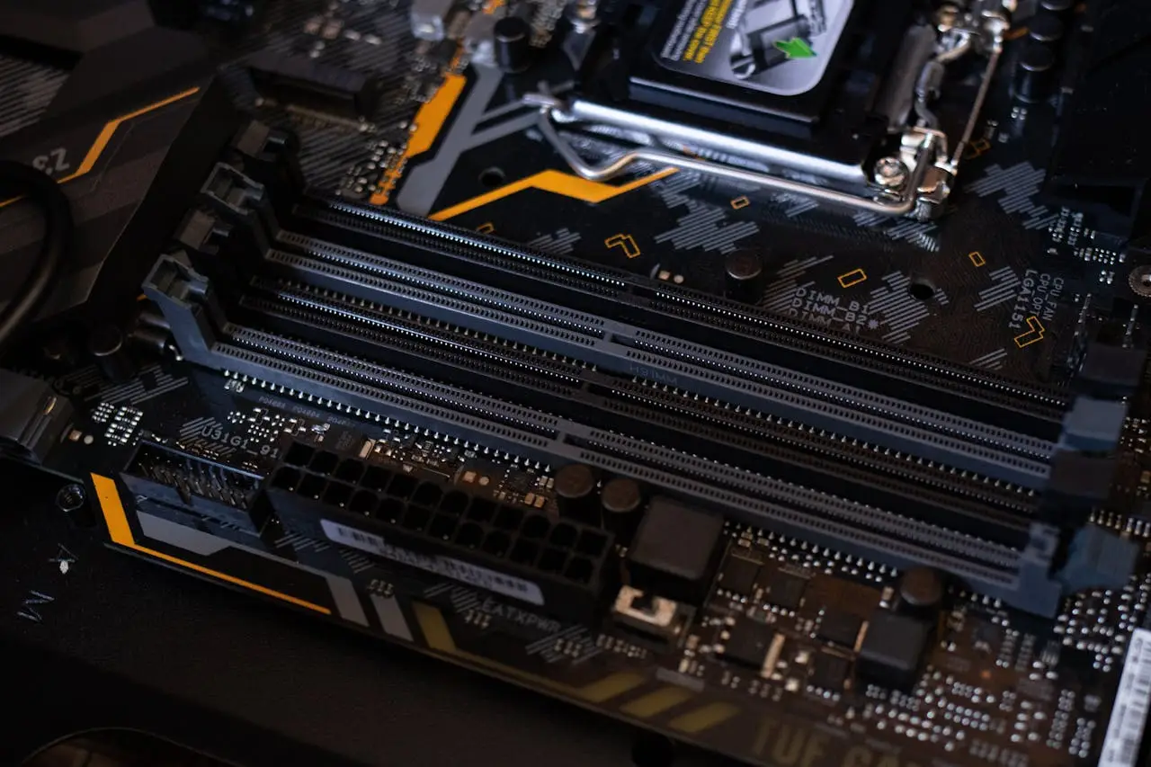 Detailed view of a computer motherboard showcasing RAM slots and electronic components.